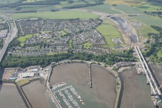 Oblique aerial view of the construction of the Queensferry Crossing and Port Edgar, looking SSW.