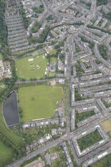 Oblique aerial view of Comely Bank Road and Edinburgh Academicals Cricket Ground, looking ESE.