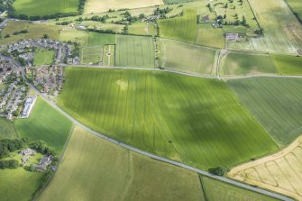 Oblique aerial view centred on the ploughed out remains of the reverse S-shaped field boundaries, looking N.