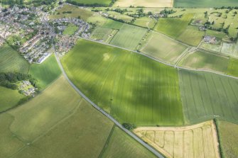 Oblique aerial view centred on the ploughed out remains of the reverse S-shaped field boundaries, looking NNW.