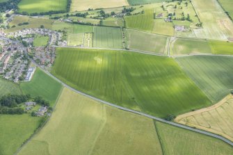 Oblique aerial view centred on the ploughed out remains of the reverse S-shaped field boundaries, looking NNW.