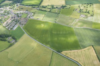 Oblique aerial view centred on the ploughed out remains of the reverse S-shaped field boundaries, looking NNW.