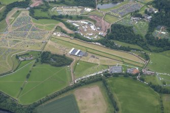 Oblique aerial view of the setting up of T in the Park at Strathallan centred on the airfield, looking SSE.