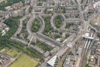 Oblique aerial view of Palmerston Place, Glencairn Crescent, Lansdowne Crescent, Grosvenor Crsecent, Douglas Crescent and Eglinton Crescent, looking E.