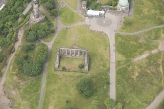 Oblique aerial view of the Calton Hill National Monument, looking W.