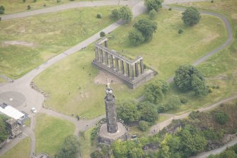 Oblique aerial view of the Calton Hill National Monument and Nelson's Monument, looking NE.