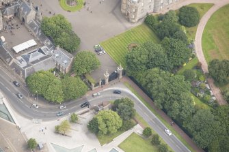 Oblique aerial view of Holyrood Palace Yard House and South Gateway, looking N.