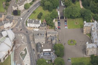 Oblique aerial view of Holyrood Palace Yard Fountain, Abbey Sanctuary, Thomson's Court and 11,13,15, Canongate, looking NW.