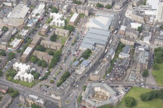 Oblique aerial view of Leith Waterworld, Leith Academy Primary School and Leith Central Station Offices, looking NW.