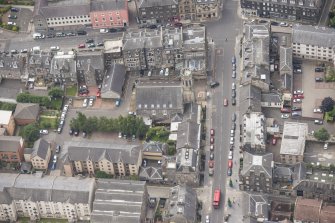 Oblique aerial view of St John's East Church, Bank of Scotland, 31-33 Queen Charlotte Street, 41 Queen Charlotte Street, 75-79 Constitution Street and 35-39 Queen Charlotte Street, looking SSW.