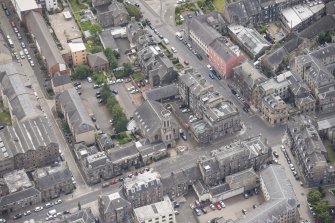 Oblique aerial view of St John's East Church, Bank of Scotland, 31-33 Queen Charlotte Street, 41 Queen Charlotte Street, 75-79 Constitution Street and 35-39 Queen Charlotte Street, looking SE.