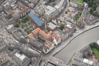 Oblique aerial view of 59-63 Bernard Street, the National Commercial Bank of Scotland, 24-25 Maritime Street, 27-31 Bernard Street, 36-37 Shore, Carpet Lane Flour Mill and Lamb's House, looking SSE.
