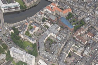 Oblique aerial view of 59-63 Bernard Street, the National Commercial Bank of Scotland, 24-25 Maritime Street, 27-31 Bernard Street, 36-37 Shore, Carpet Lane Flour Mill and Lamb's House, looking NNW.