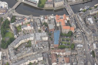 Oblique aerial view of 59-63 Bernard Street, the National Commercial Bank of Scotland, 24-25 Maritime Street, 27-31 Bernard Street, 36-37 Shore, Carpet Lane Flour Mill and Lamb's House, looking NW.