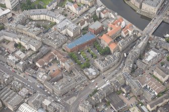 Oblique aerial view of 59-63 Bernard Street, the National Commercial Bank of Scotland, 24-25 Maritime Street, 27-31 Bernard Street, 36-37 Shore, Carpet Lane Flour Mill and Lamb's House, looking W.