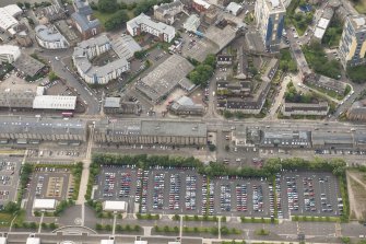 Oblique aerial view of Commercial Street, St Ninian's Church,  102 Commercial Street Bonded Warehouse 35, 46 and 48, 72-88 Commercial Street Warehouses, 65 Commercial Street and 92-96 Commercial Street Warehouses, lookingSSW.