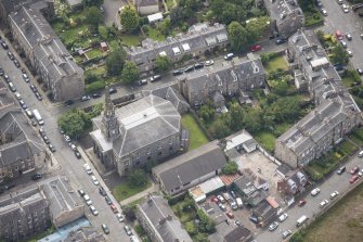 Oblique aerial view of North Leith Parish Church, Church hall and Beadle's House, looking S.