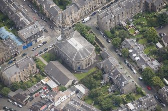 Oblique aerial view of North Leith Parish Church, Church hall and Beadle's House, looking E.