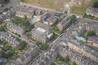 Oblique aerial view of North Leith Parish Church, Church hall and Beadle's House, looking W.