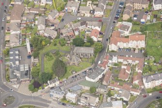 Oblique aerial view of St Triduana's Chapel, Restalrig Parish Church and Churchyard, looking NNW.