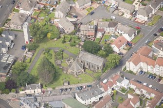 Oblique aerial view of St Triduana's Chapel, Restalrig Parish Church and Churchyard, looking NW.