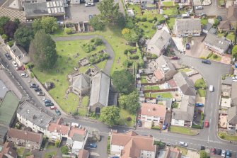 Oblique aerial view of St Triduana's Chapel, Restalrig Parish Church and Churchyard, looking WSW.