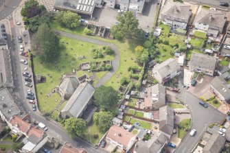 Oblique aerial view of St Triduana's Chapel, Restalrig Parish Church and Churchyard, looking SSW.