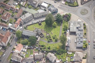 Oblique aerial view of St Triduana's Chapel, Restalrig Parish Church and Churchyard, looking SE.