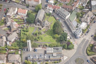 Oblique aerial view of St Triduana's Chapel, Restalrig Parish Church and Churchyard, looking E.