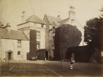 View of The Peel, Busby from south east showing a tennis court at the back of house