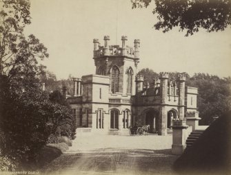 View of Calderwood Castle with horse-drawn carriage outside the entrance