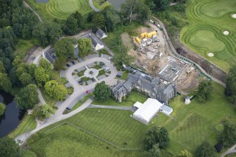 Oblique aerial view of Meldrum House, North Garden House,stables and dovecot, looking N.