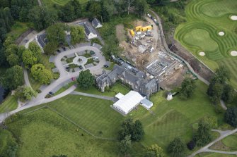 Oblique aerial view of Meldrum House, North Garden House,stables and dovecot, looking NNW.