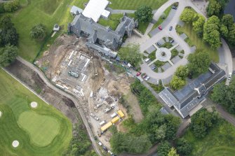 Oblique aerial view of Meldrum House, North Garden House,stables and dovecot, looking S.