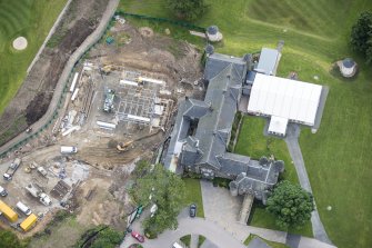 Oblique aerial view of Meldrum House and North Garden House, looking E.