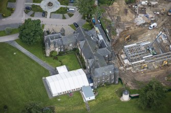 Oblique aerial view of Meldrum House and North Garden House, looking NW.