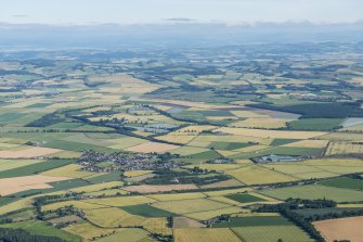 General oblique aerial view of the Howe of Fife with Freuchie and Auchtermuchty in the distance, looking NW.