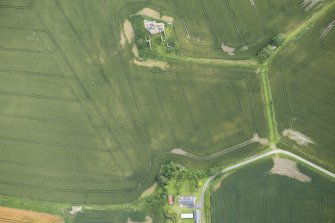 Oblique aerial view of Inchdrewer Castle and the cropmarks of the ditch, looking NE.
