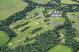 Oblique aerial view of Meldrum House and Golf Course, looking SW.