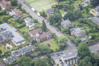 Oblique aerial view of St Cuthbert's Episcopal Church and 1-7 Colinton Rustic Cottages, looking S.