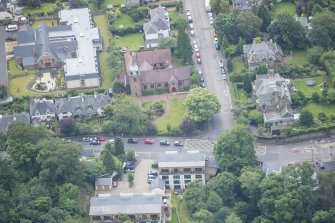 Oblique aerial view of St Cuthbert's Episcopal Church and 1-7 Colinton Rustic Cottages, looking SSE.