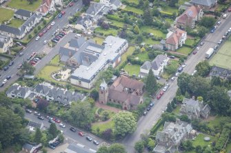 Oblique aerial view of St Cuthbert's Episcopal Church and 1-7 Colinton Rustic Cottages, looking SE.