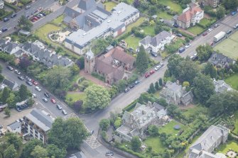 Oblique aerial view of St Cuthbert's Episcopal Church and 1-7 Colinton Rustic Cottages, looking E.