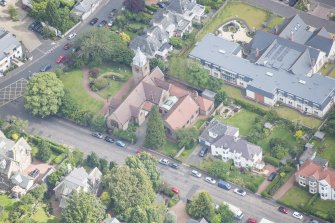 Oblique aerial view of St Cuthbert's Episcopal Church and 1-7 Colinton Rustic Cottages, looking NNE.