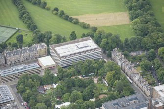Oblique aerial view of 17-19 Buccleuch Place and University of Edinburgh Library, looking SSE.