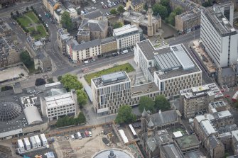 Oblique aerial view of Nicolson Square Methodist Chapel, University Student's Union, Central Mosque and the Informatics Forum Building, looking E.