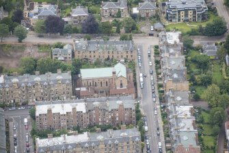 Oblique aerial view of St Peter's Roman Catholic Church and Presbytery, looking N.