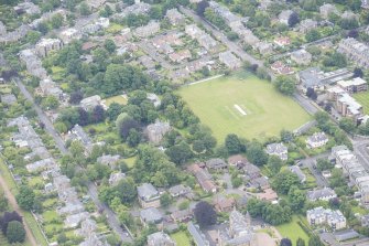 Oblique aerial view of The Lane House and Grange Road, looking E.