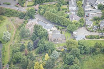 Oblique aerial view of Duddingston Parish Church, Churchyard and Watch Tower, looking NNW.