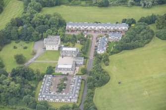 Oblique aerial view of Duddingston House, Offices and Stables, looking S.